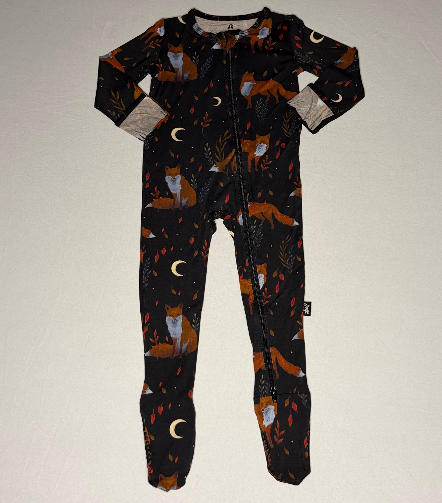 Children's onesie with fox pattern on a plain background